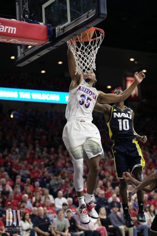 Arizonas Allonzo Trier dunks the ball past NAUs Malcolm Allen. Trier recorded a career-high 32 points.