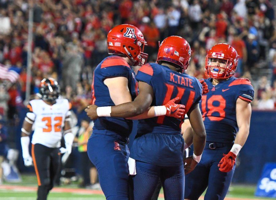 Arizonas+Khalil+Tate+%2814%29+hugs+a+teammate+following+his+touchdown+during+the+3rd+quater+of+the+UA-Oregon+State+game+on+Nov.+11+at+Arizona+Stadium.