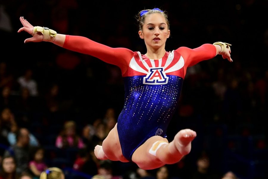 Madison Cindric does a midair split while warming up for her floor routine during Arizonas 194.025-191.600 win over Utah State and Texas Womans in McKale Center on Jan. 6.