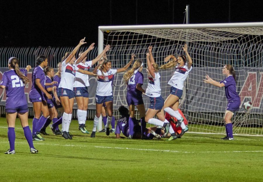 The+Arizona+soccer+team+celebrates+after+a+goal+during+their+game+against+Texas+Christian+Univeristy+on+Nov.+10.+The+Wildcats+won+2-1%2C+advancing+them+on+to+the+second+round+of+the+NCAA+tournament.