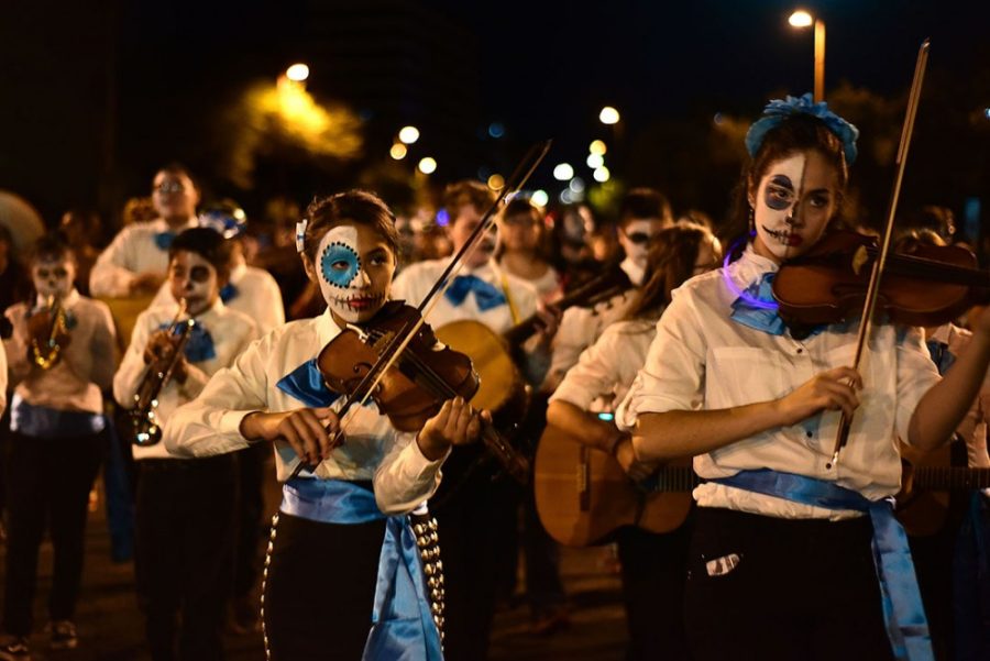 Violinists play as they walk down Alameda Street during the 2016 All  Souls Procession in downtown Tucson on Nov. 6, 2016. The All Souls  Procession began with an artist’s wish to honor her father who had  recently died. 