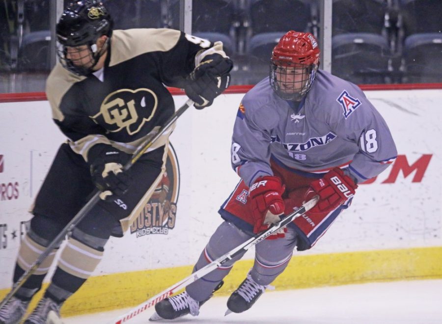 Arizona's Ethan Stahlhuth (18) skates with a CU player during a hockey game at Tucson Convention Center on Nov. 2. Stahlhuth has 13 points, including eight goals and five assists.