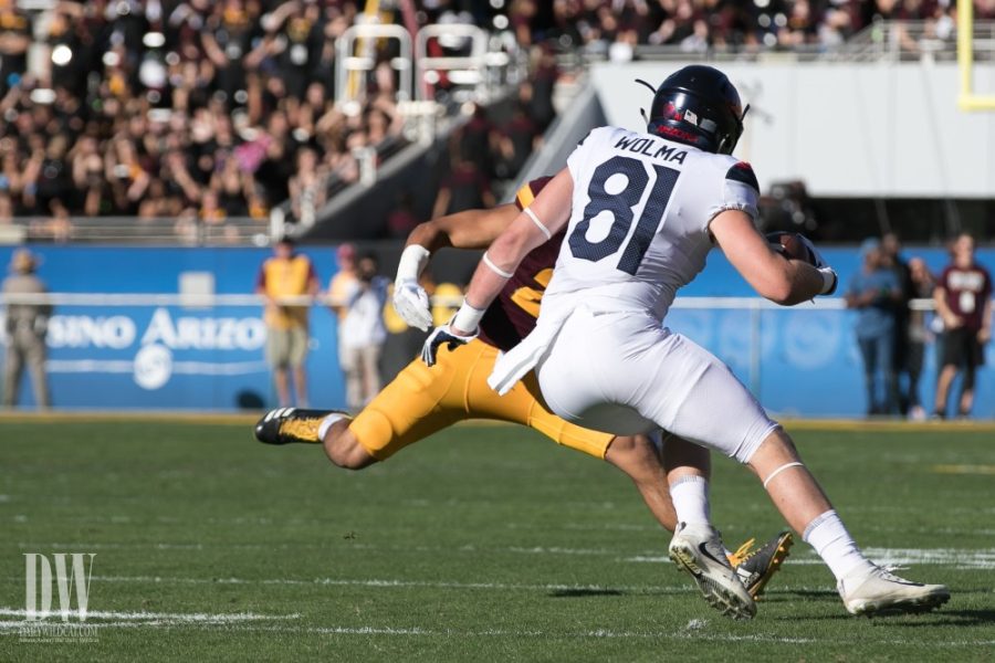 Arizonas Bryce Wolma jukes and throws off an ASU defender during the first quarter of the UA-ASU game in 2017. 