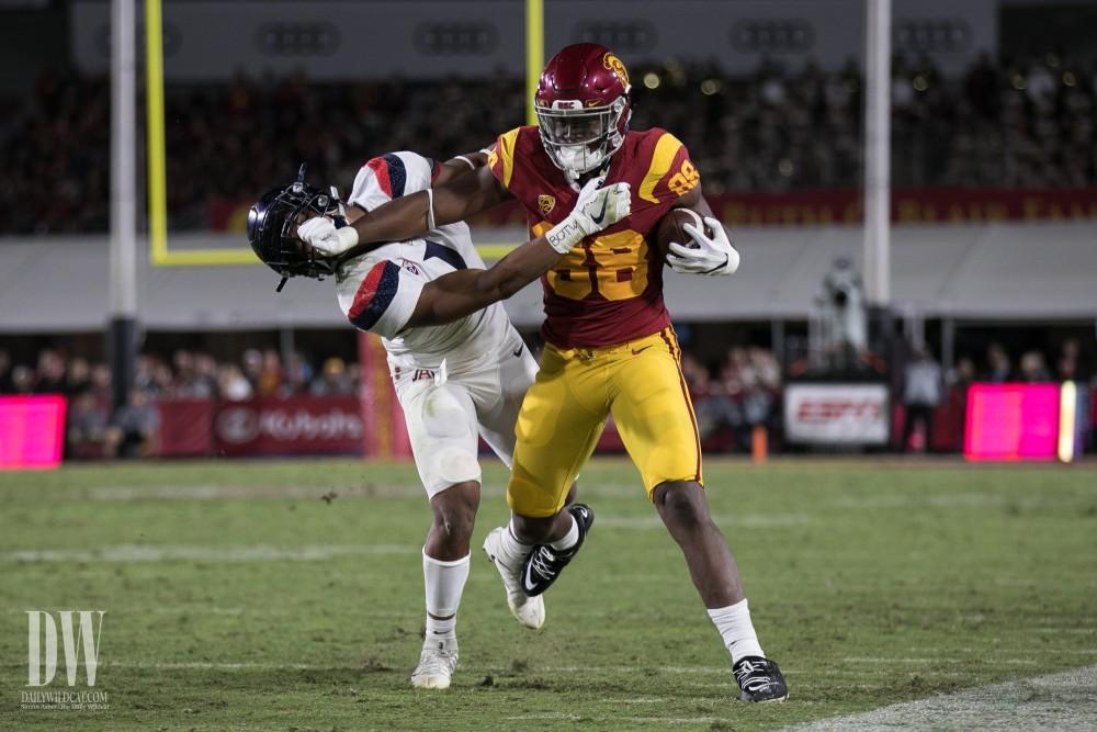 Arizona's Tony Fields II (1) is pushed aside by USC's Daniel Imatorbhebhe (88) during the UA-USC football game in Los Angeles, Calif.