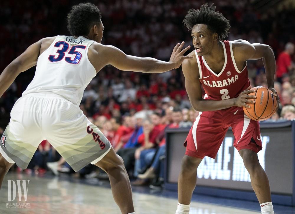 Alabama's Collin Sexton eyes the court for an open teammate, looking past Arizona's Allonzo Trier. Sexton fiished the game by fouling out with 30 points.