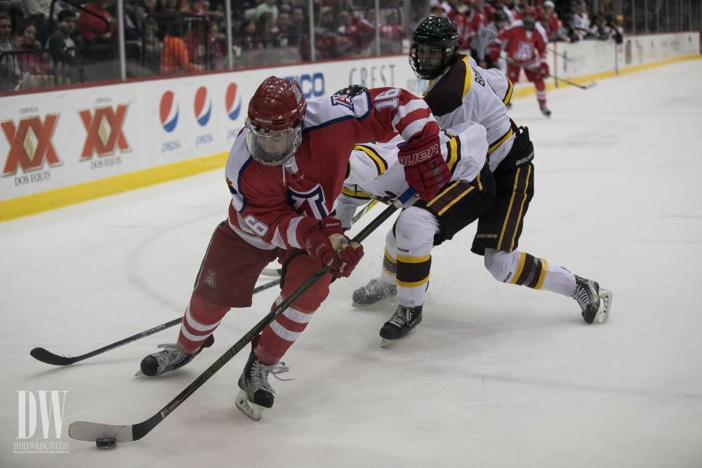 Arizona's Tyler Griffith nabs the puck away from two Arizona State players.
