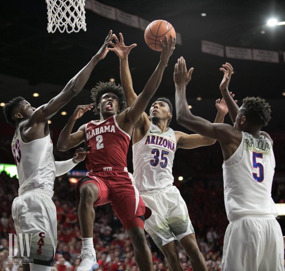 Alabama's Collin Sexton lays in a shot regardless of being surrounded by Arizona defense. Sexton finished the game with 30 points.