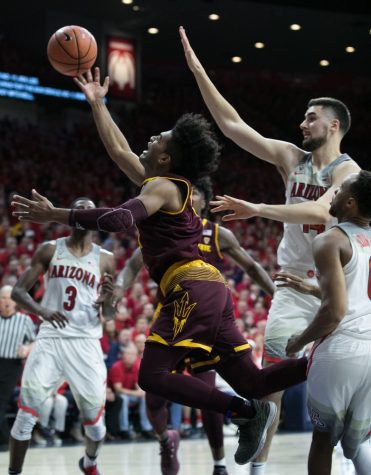 Arizona State's Remy Martin flops past Arizona's Dusan Ristic and Parker Jackson-Cartwright. Martin had 11 points on the night.