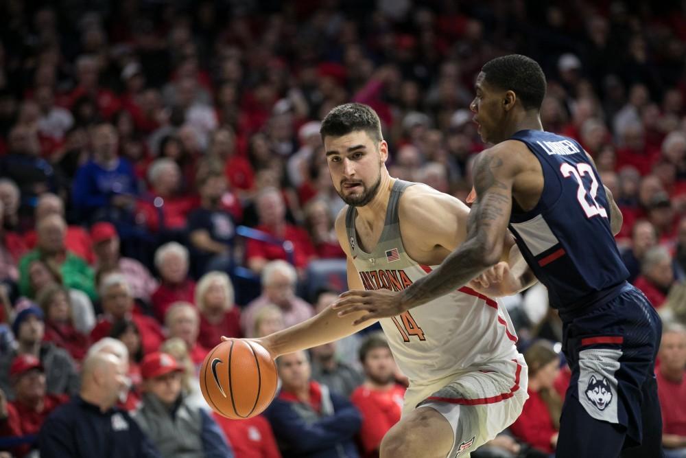 Arizona's Dusan Ristic pushes his way towards the basket against UConn's Terry Larrier (22). Ristic recorded a double-double with 18 points and 10 rebounds.