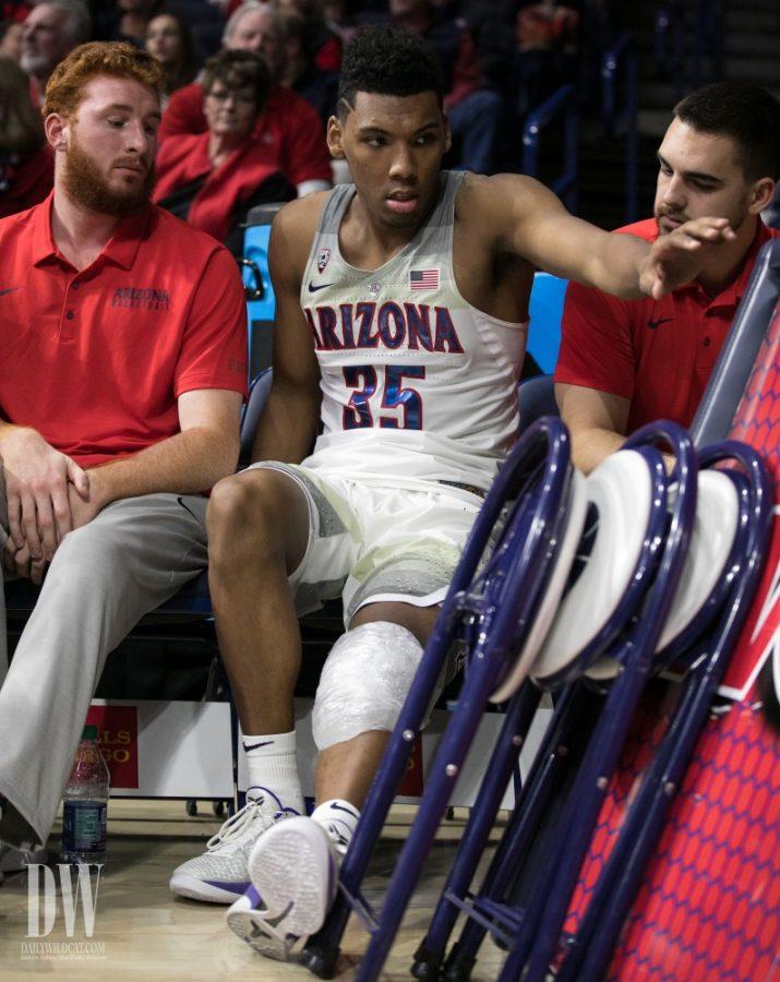 Allonzo Trier rests on the bench after leaving the Arizona-North Dakota game with a knee injury. Trier left the game with 15 points.
