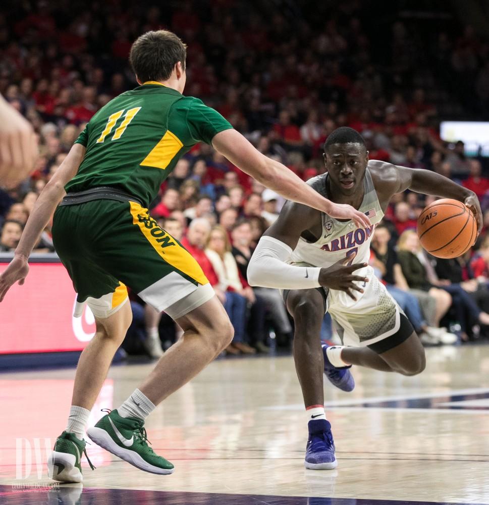 Arizona's Rawle Alkins hesitates, trying to trip up North Dakota's Jared Samuelson (11) before taking a step-back shot. Alkins had 11 points in the game.