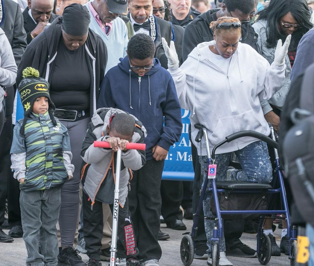 Families gather in prayer prior to the  33rd annual Martin Luther King Day March in Tucson, AZ January 15, 2018.