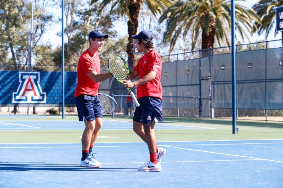 Arizona+players+Trent+Botha+%28left%29+and+Andres+Reyes+%28right%29+celebrate+their+success+as+doubles+partners+during+the+match+againt+Saint+Marys.