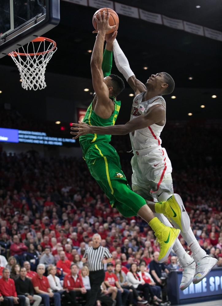 Arizona's Brandon Randolph, right, blocks a dunk by Oregon's Elijah Brown, left. Randolph had no points in the game and two assists.