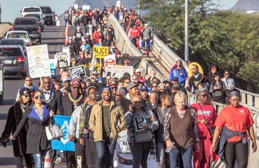 Hundreds of marchers in the 33rd annual Martin Luther King March make their way down the bridge on 22nd St east of Kino Blvd on the way to a celebration at Reid Park in Tucson, AZ January 15, 2018.