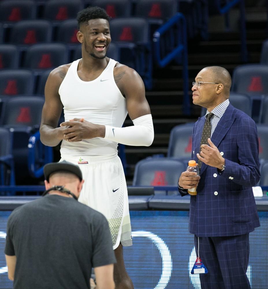 Arizona's Deandre Ayton and Gus Johnson share a laugh during pre-game warmups.