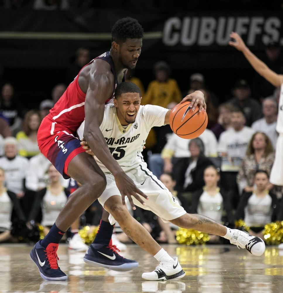 Arizona's Deandre Ayton, left, reaches in to try and steal the ball from Colorado's Dominique Collier, right.