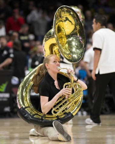 A Colorado band member does the splits during the Colorado University Tuba Cheer.