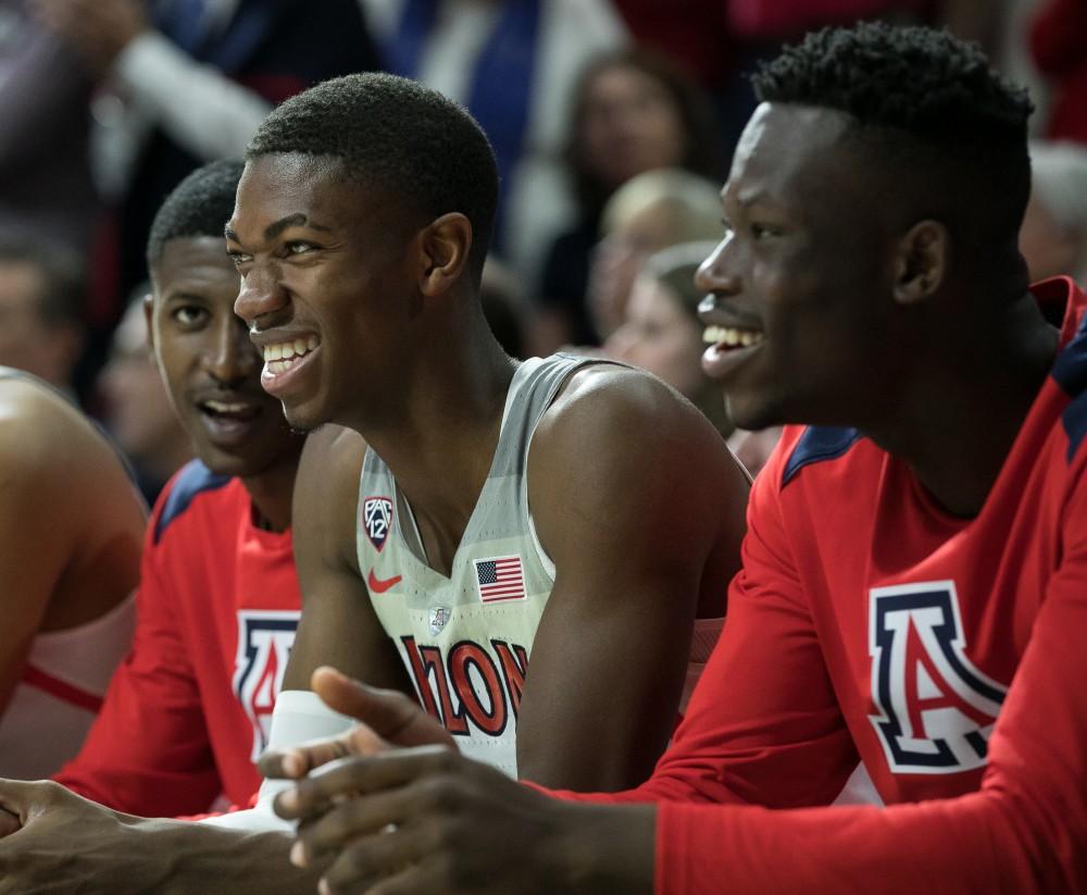 Brandon Randolph, left, and Emmanuel Akot, right, watch with pride as a foul is called on Oregon late in the UA-Oregon game.