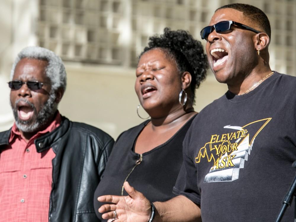 Vernon Wilhite, right, and singers with the Gospel Workshop of America, Tucson Chapter, give it their all during the 33rd annual Martin Luther King Day celebration at Reid Park in Tucson, AZ January 15, 2018.