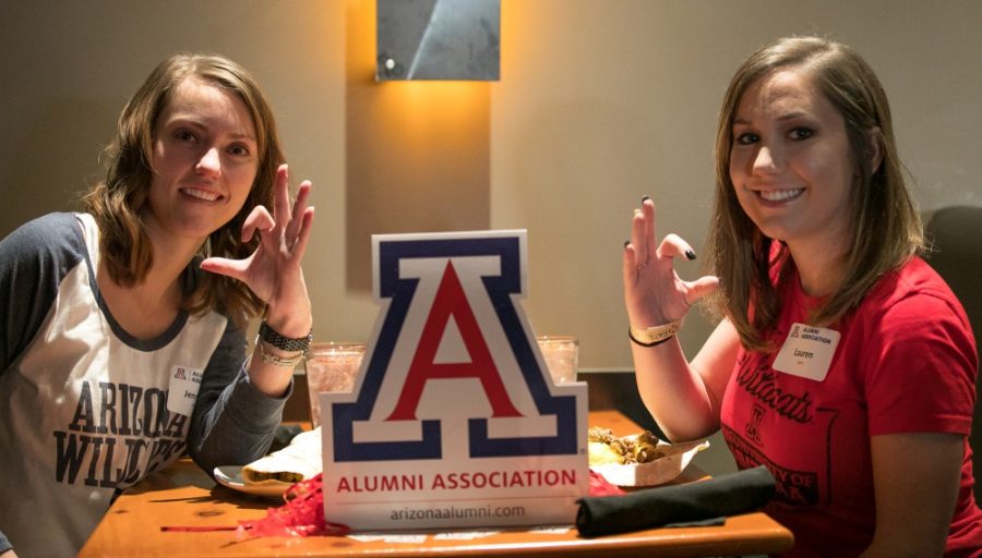 Jennifer Keefe, left, and Lauren Cohrs, right, show their wildcat pride during the Colorado Cats alumni brunch.