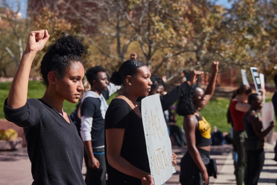 Students held up clenched fists during the Black Lives Matter silent protest on Feb. 5. 
