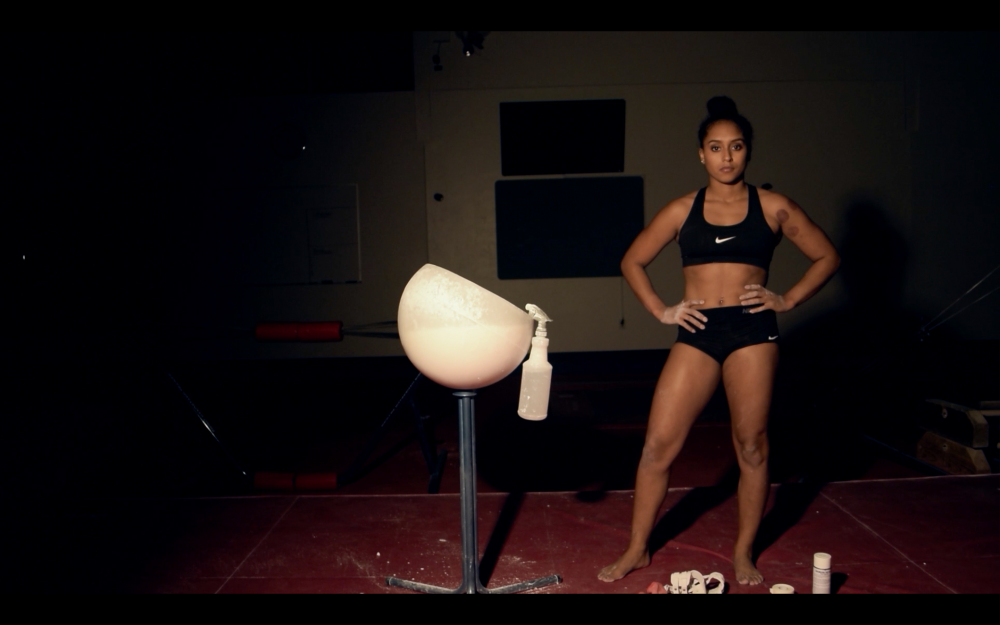 Still from video works that Schneider exhibited in fall of 2017 at the Loft Cinema in Tucson, Ariz. for a group show titled "Gesticulate". Both works drew from my experiences as a black, female athlete. Titled "Uneven Bars" (2017)