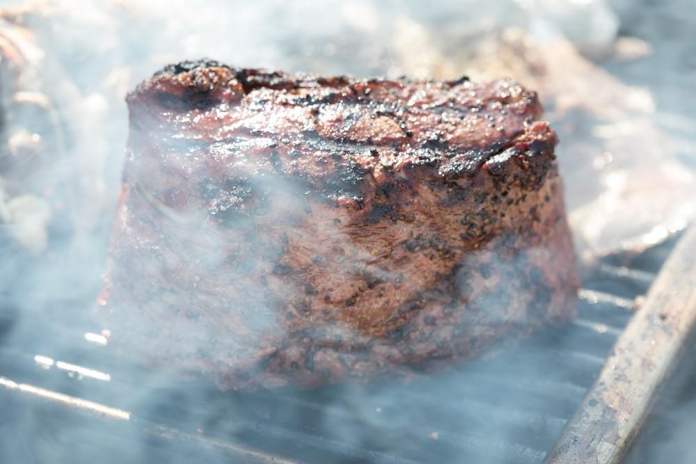 Red's Smokehouse & Taproom smokes a chunk of New York Strip Steak in preparation for the SAVOR Food & Wine Festival.
