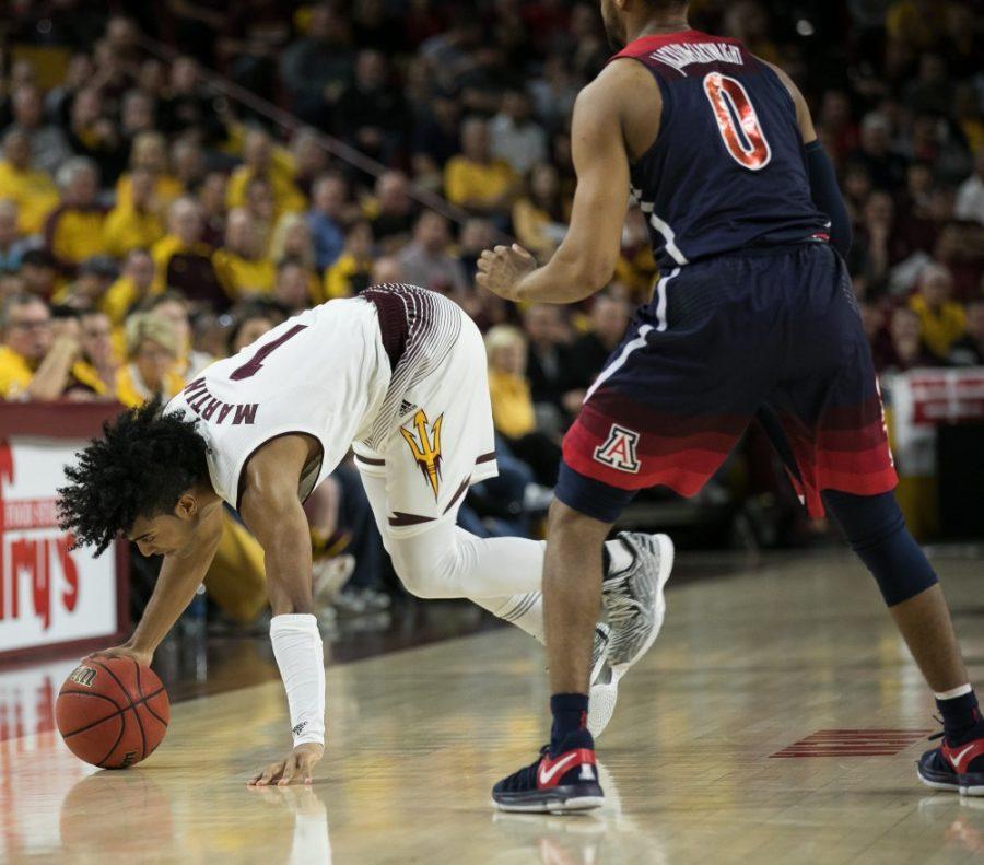 Arizona States Remy Martin (1) trips trying to get away from Arizonas Parker Jackson-Cartwright (0) during the frst half of the Arizona-Arizona State game on Thursday, Feb. 15 in Wells Fargo Arena in Phoenix, Ariz. At the half, Arizona is up 39-38.