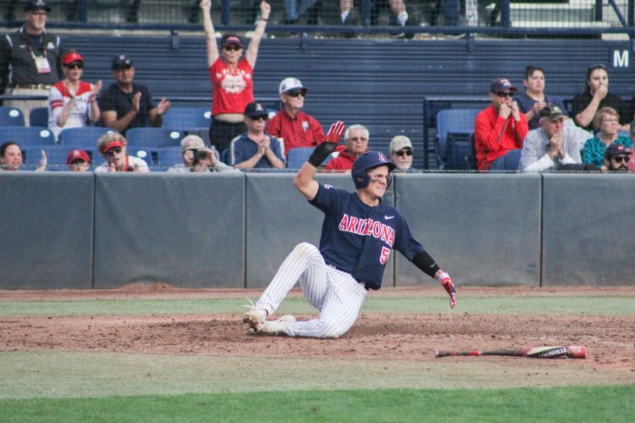 Arizonas Travis Moniot (5) slides into home base adding a point to the scoreboard during the opening game of the season against Bryant on Feb. 17, 2018 at Hi-Corbett Field, in Tucson, Ariz.