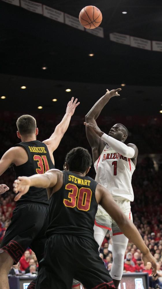 Arizona's Rawle Alkins floats in the ball over USC's Nick Rakocevic (31) and Elijah Stewart (30) during the second half of the UA-USC game on Saturday, Feb. 10 at McKale Center in Tucson, Ariz. Alkins had 20 points on the night.