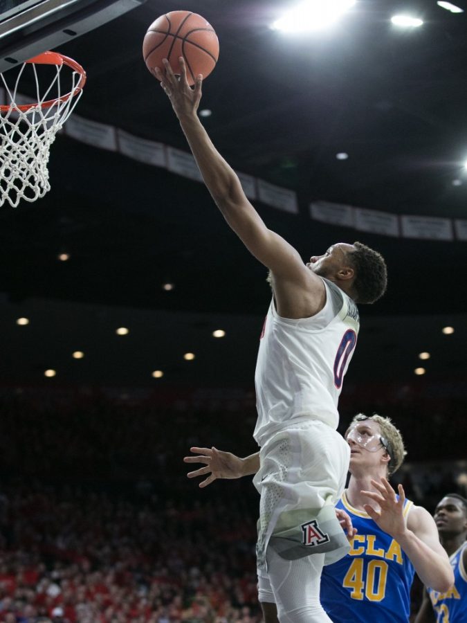 Arizonas Parker Jackson-Cartwright (0) lays in the ball past UCLAs Thomas Welsh (40) during the UA-UCLA game on Thursday, Feb. 8 at McKale Center in Tucson, Ariz. Jackson-Cartwright had 10 points in the game.