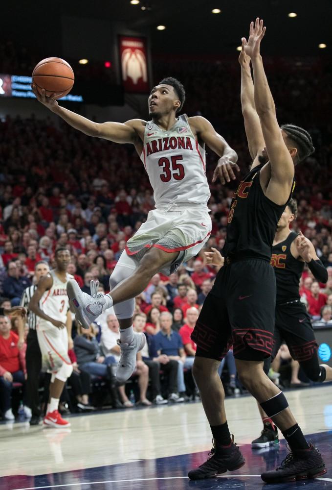 Arizona's Allonzo Trier (35) goes for a fancy layup past USC's Bennie Boatwright during the second half of the UA-USC game on Saturday, Feb. 10 at McKale Center in Tucson, Ariz.