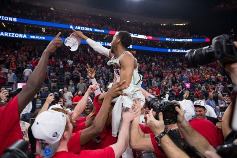 Parker Jackson-Cartwright is held up during the celebrations after the championship victory over the Arizona-USC Championship game at the 2018 Pac-12 Tournament on Saturday, March 10 in T-Mobile Arena in Las Vegas, Nev.
