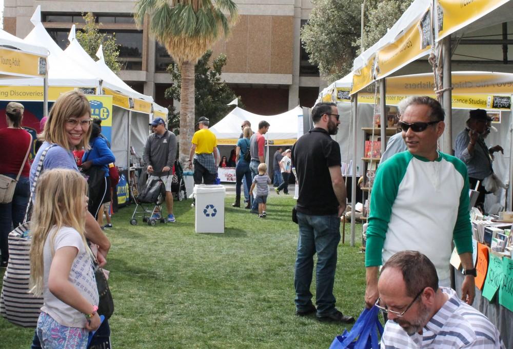 Visitors of the 2018 Tucson Festival of Books enjoy the booths the festival has to offer. They range from publishers to booksellers to other organizations contributing to the festival.