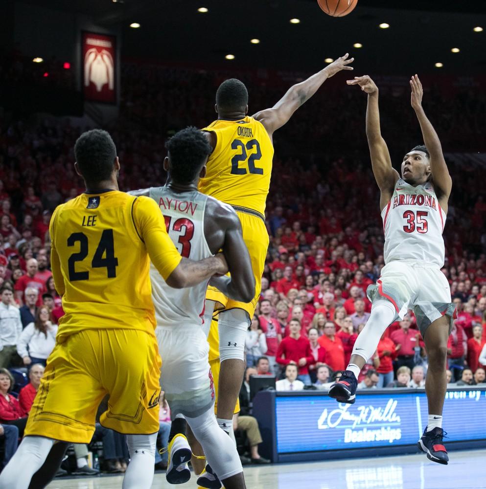 Arizona's Allonzo Trier takes a wild shot past Cal's Kingsley Okoroh (22) in the second half of the Arizona-Cal game on Saturday, March 3 in McKale Center. Trier went 1-for-10 shooting on the night.