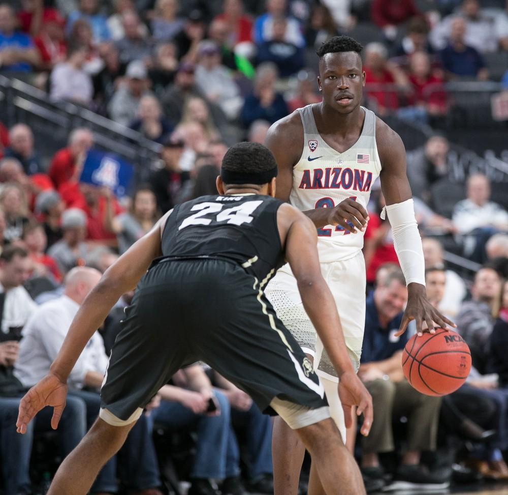 Arizona's Emmanuel Akot (24) looks for a teammate to pass to during the Colorado-Arizona Quarterfinal game at the 2018 Pac-12 Tournament on Thursday, March 8 in T-Mobile Arena in Las Vegas, Nev.