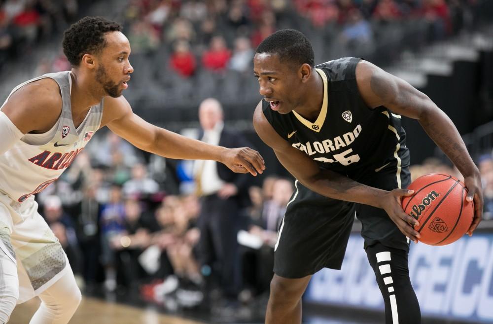 Colorado's McKinley Wright IV (25) holds the ball away from Arizona's Parker Jackson-Cartwright (0) in the first half of the Colorado-Arizona Quarterfinal game at the 2018 Pac-12 Tournament on Thursday, March 8 in T-Mobile Arena in Las Vegas, Nev.