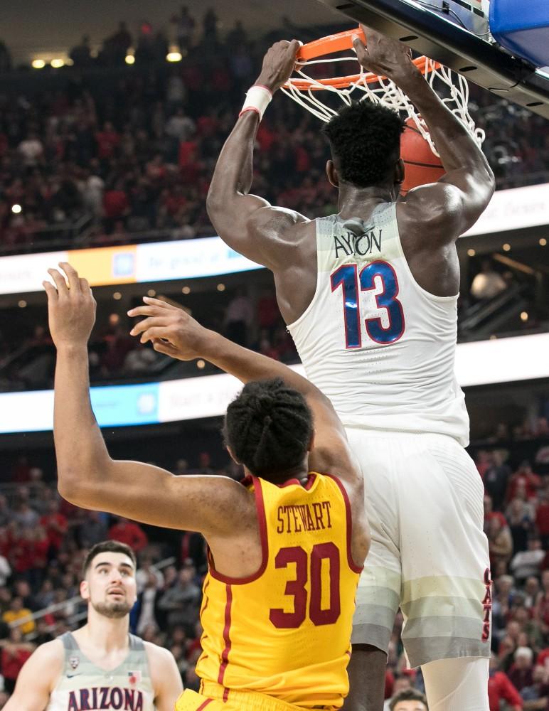 Arizona's Deandre Ayton dunks past USC's Elijah Stewart (30) in the Arizona-USC Championship game at the 2018 Pac-12 Tournament on Saturday, March 10 in T-Mobile Arena in Las Vegas, Nev. Ayton finished with 32 points and 18 rebounds.