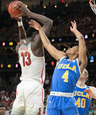 Arizona's Deandre Ayton (13) grabs a rebound over UCLA's Jaylen Hands (4) in the Arizona-UCLA Semifinal game at the 2018 Pac-12 Tournament on Friday, March 9 in T-Mobile Arena in Las Vegas, Nev. Ayton had 14 rebounds in the game.