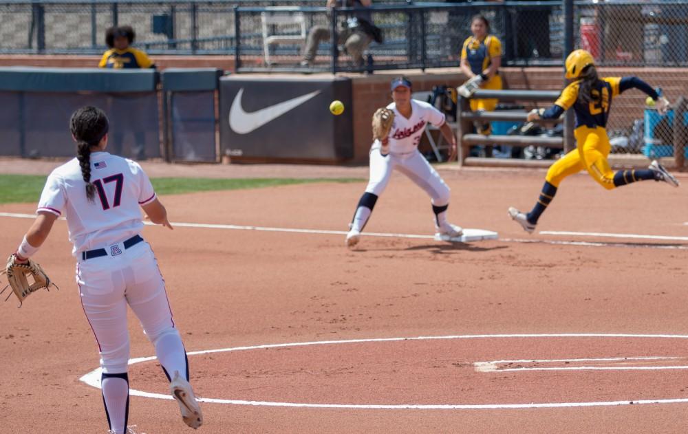 Arizona's Malia Martinez throws to first base, getting Cal's hitter out during the Arizona- California game at Rita Hillenbrand Memorial Stadium on Saturday March 31 in Tucson Ariz.