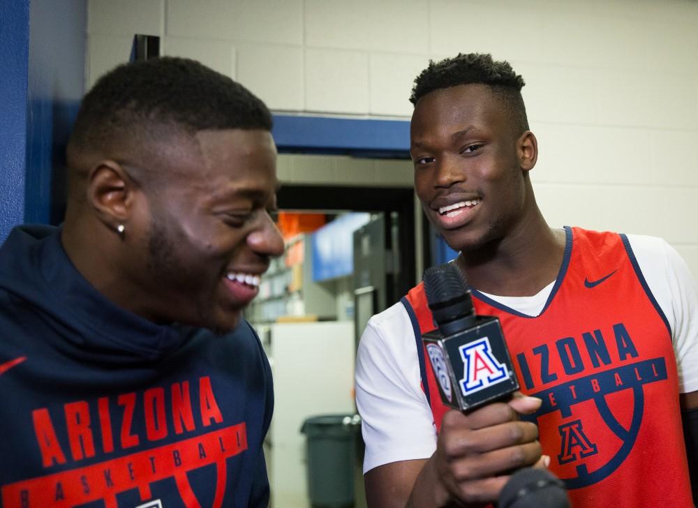 Arizona freshman Emmanuel Akot, right, interviews sophomore Rawle Alkins, left, in the Arizona locker room in Boise, Idaho.