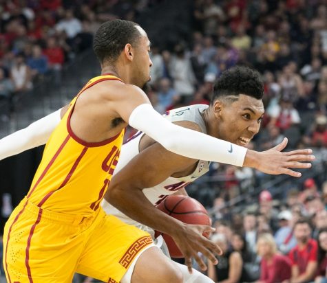 Arizona's Allonzo Trier, center, pushes past USC's Jordan McLaughlin (11) in the Arizona-USC Championship game at the 2018 Pac-12 Tournament on Saturday, March 10 in T-Mobile Arena in Las Vegas, Nev.