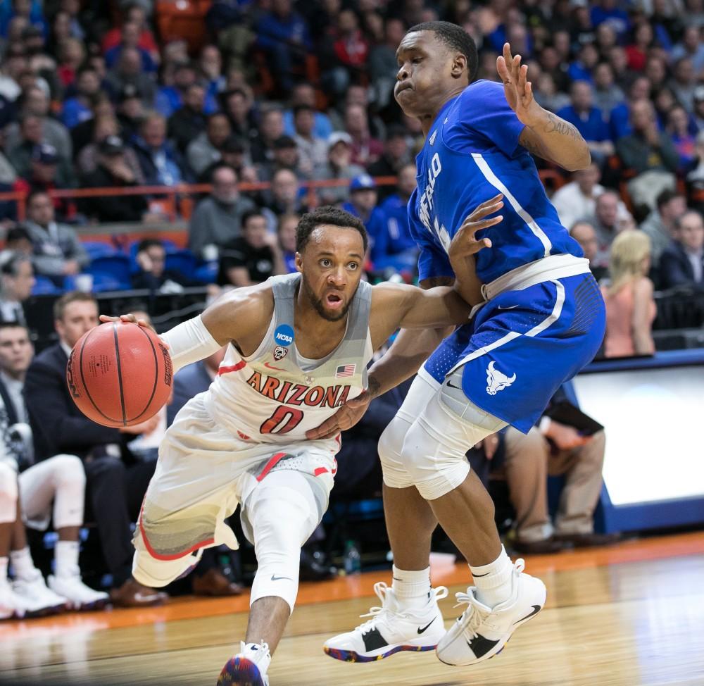 Arizona's Parker Jackson-Cartwright (0) pushes past Buffalo's Davonta Jordan (4) in the Arizona-Buffalo game in the first round of the NCAA Tournament on Thursday, March 15 in Boise, Idaho.