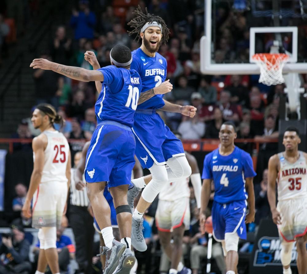 Buffalo's Wes Clark (10) and Jeremy Harris (2) celebrate a blowout win against Arizona in the first round of the NCAA Tournament on Thursday, March 15 in Boise, Idaho.