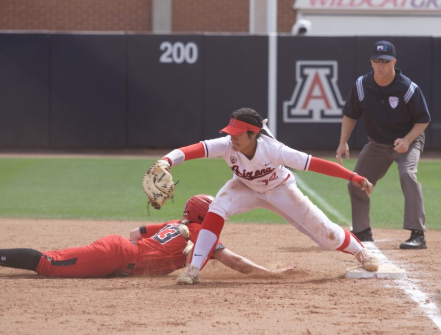 Wildcat Alyssa Palomino successfully catches an incoming ball, getting Utah’s hitter out during the game on Sunday, March 18. 
