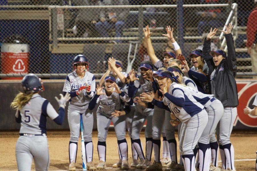 Arizonas softball team cheers on its teammate who just scored a home run during the game against ULM on Feb. 18.