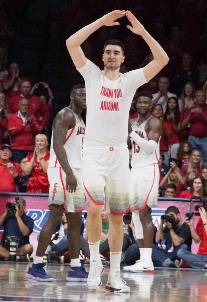 Arizona's Dusan Ristic (14) throws up his signature sign as he waves goodbye to the fans and steps of the Arizona court for the last time during the Arizona-California game on Saturday March 3 at McKale Center