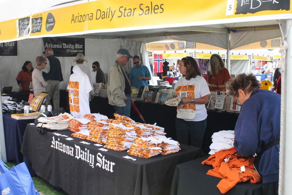 Arizona Daily Star, a sponsor of the Tucson Festival of Books, has a tent selling merchandise. They sell bags, books, t-shirts, bottles and posters.