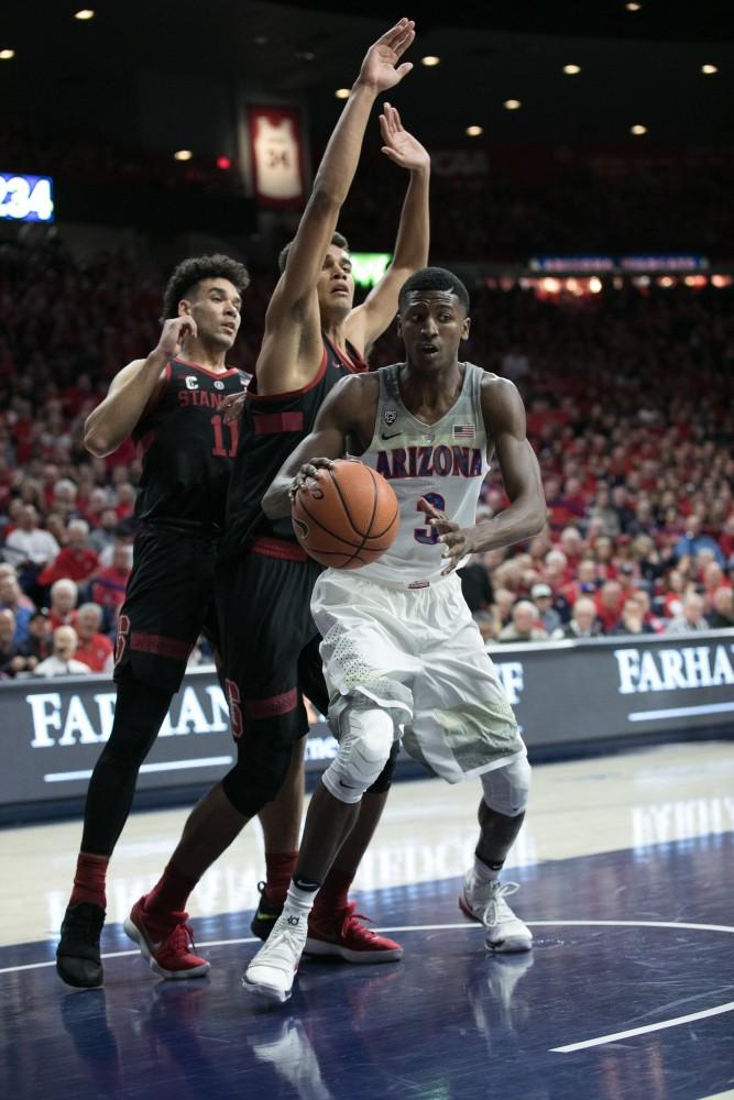 Arizona's Dylan Smith (3) grabs an offensive rebound during the first half of the Arizona-Stanford game on Thursday, March 1 at McKale Center in Tucson, Ariz.